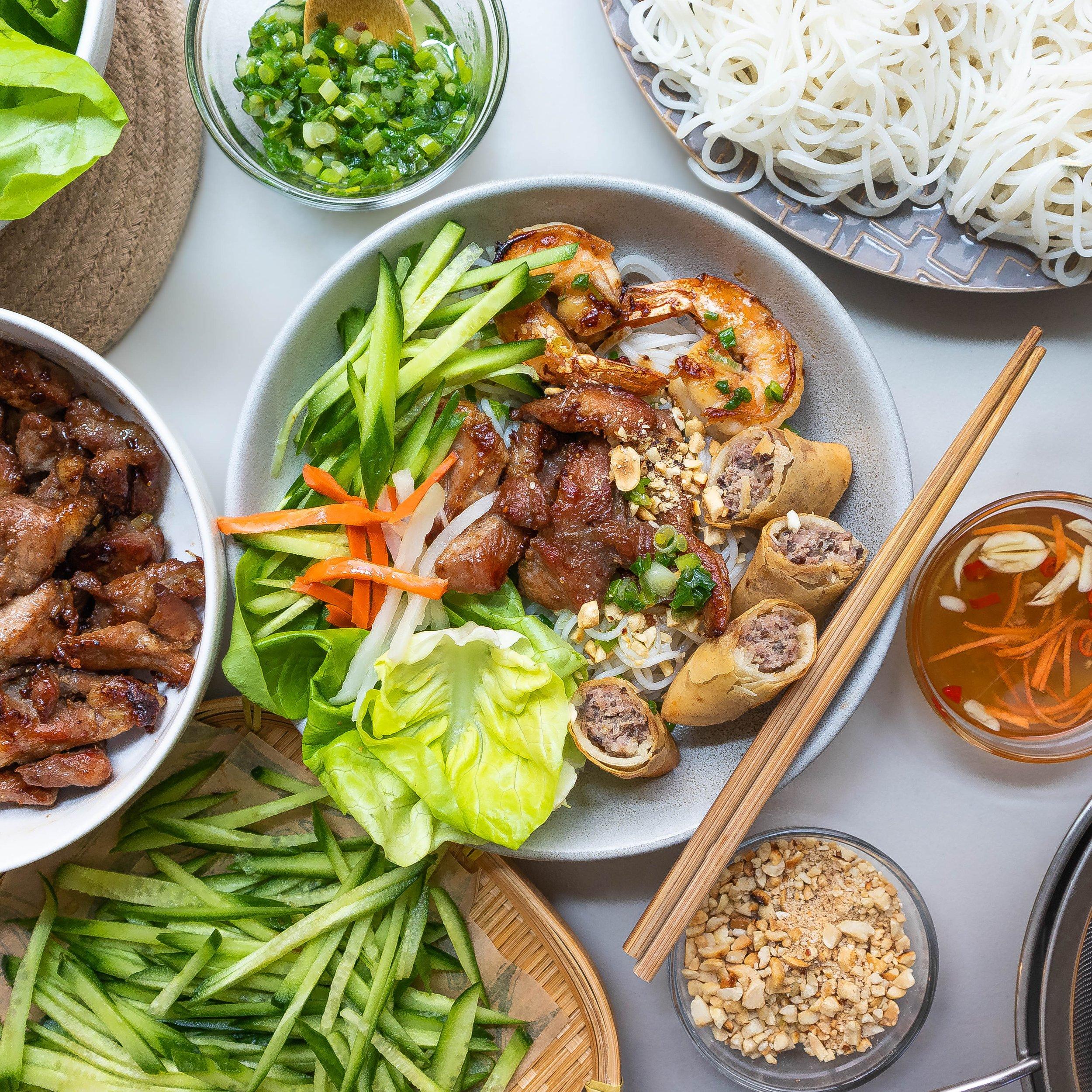 Juicy grilled pork meatballs served with fresh vermicelli noodles and herbs.