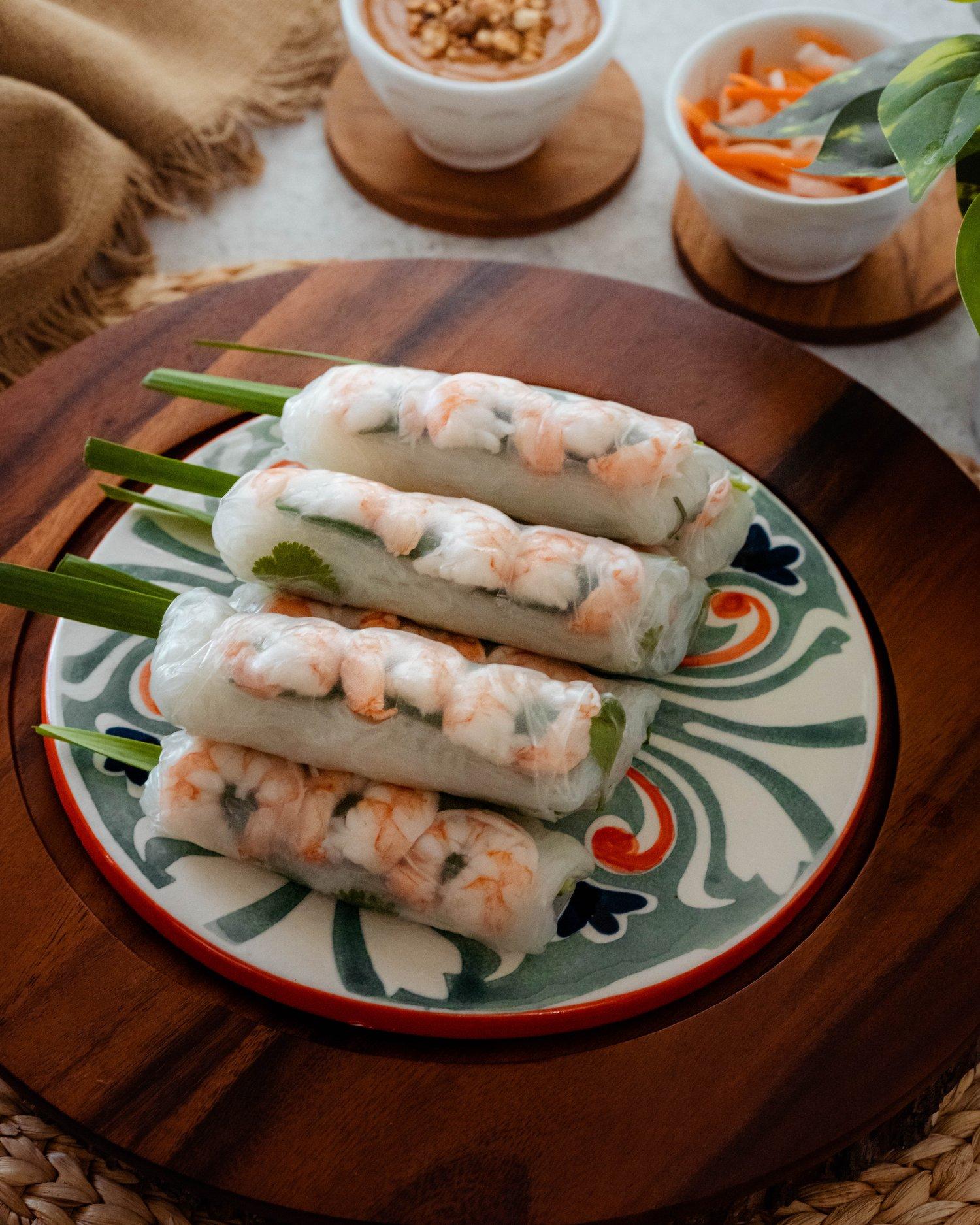 A platter showcasing the variety of Vietnamese spring rolls, including fried spring rolls, fresh spring rolls, and banh xeo.