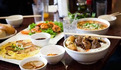 A steaming bowl of Pho at Com Com Restaurant, showcasing the vibrant colors and fresh ingredients of Vietnamese cuisine.