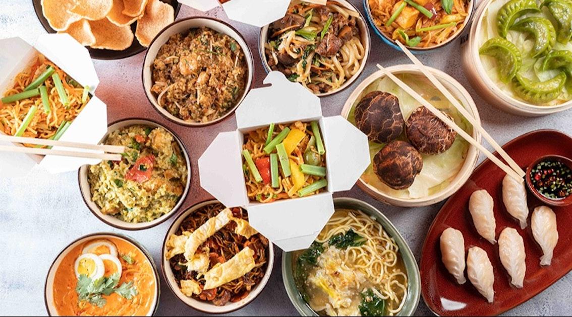 Wok-fried prawns with egg noodles, vibrant vegetables, and fresh herbs.