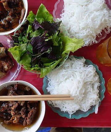 Hanoi street food vendor preparing bun cha